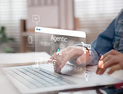 Person interacting with Agentic AI interface on laptop.