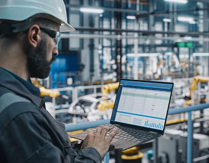 Factory engineer work uniform using laptop.