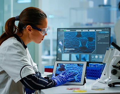 Scientist using digital tablet analysing virus evolution, treatment development in medical research laboratory.