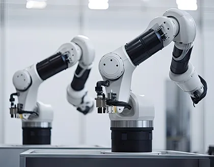 Two robot arms in factory.