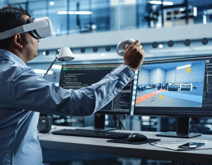 Automotive Engineer using a laptop with VR Software.