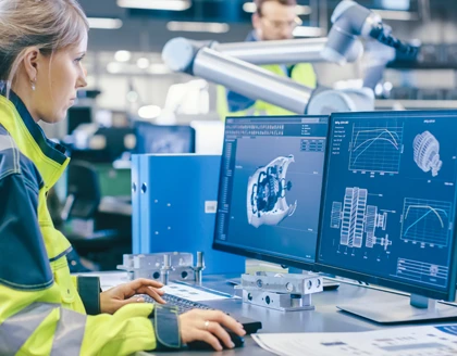 Female Mechanical Engineer Designs 3D Engine on computer.