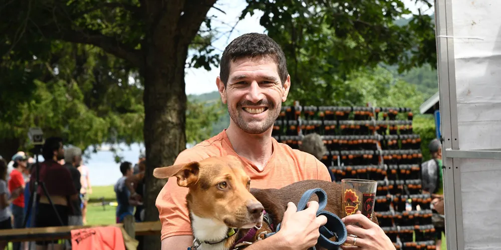 man holding dog smiling