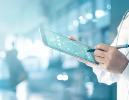 Health care worker with a tablet and a stylus.